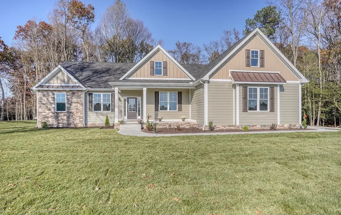A finished craftsman home with stone skirting on a Delaware lot.